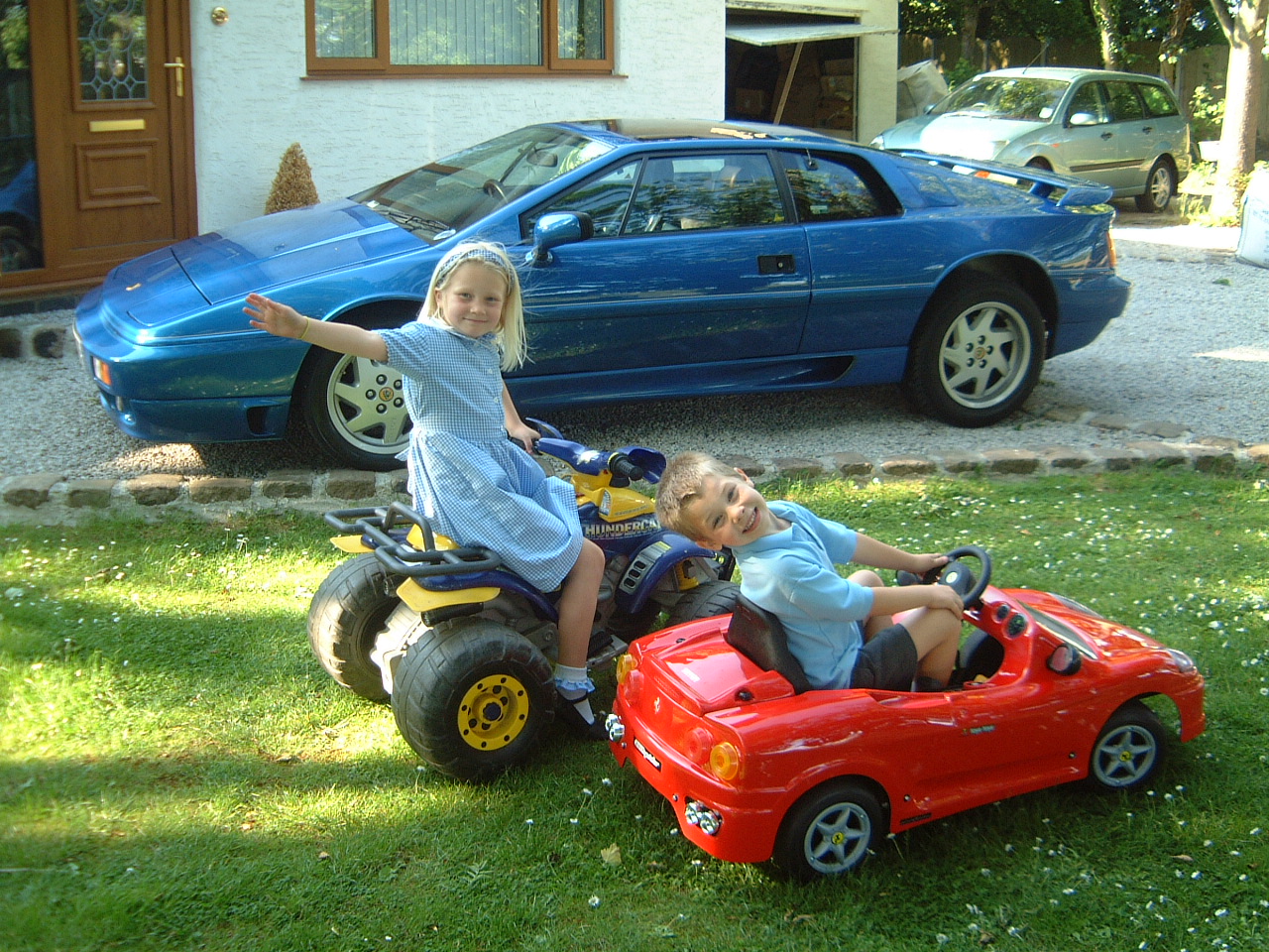 Hollie and Jordan beside Bibster's blue Lotus Esprit Turbo SE registration H15 LTS